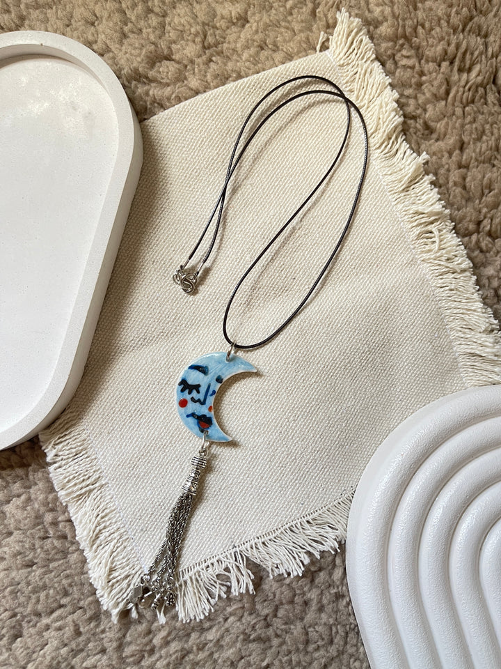The moon face in blue necklace