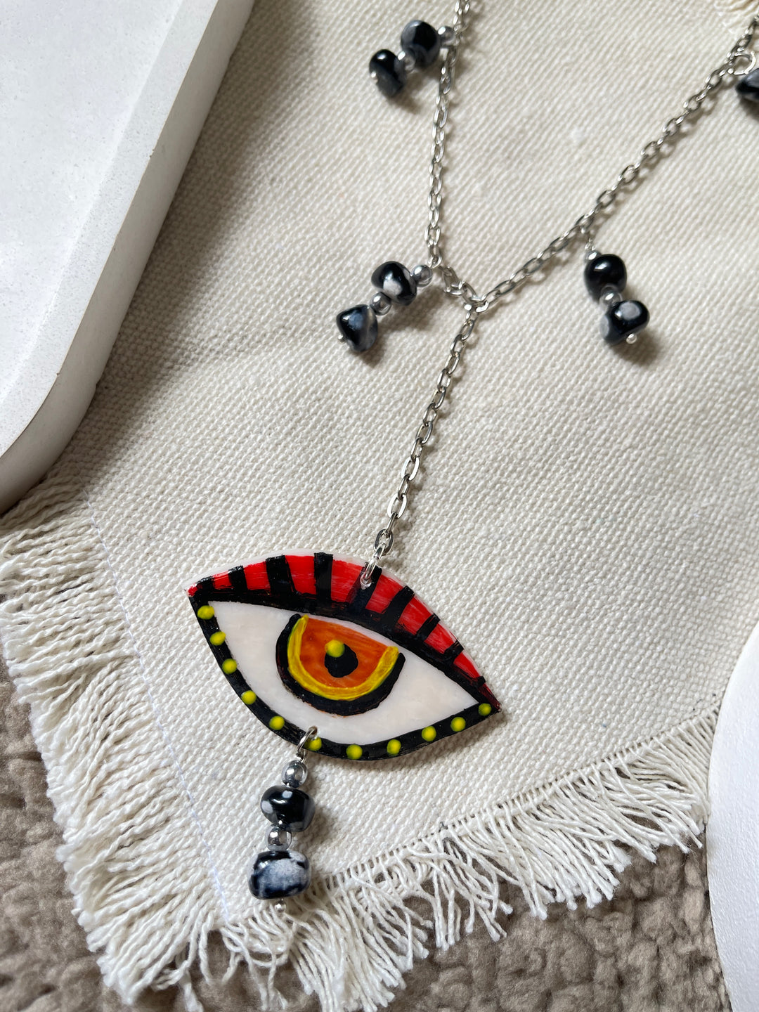 The eye in red necklace