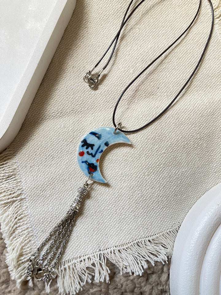 The moon face in blue necklace
